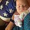 Saige is registered to the contest to win money with this photo: baby, sleeping, mittens, striped_clothing, pillow, stars, couch, arm, hand, person, indoor, cozy, resting, face, head, infant, closeup, comfort, blanket, fabric