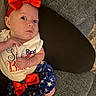baby, blue_skirt, child, clothing, couch, cute, expression, fabric, feet, hand, headband, indoors, infant, pattern, person, portrait, red_bow, sitting, stars, white_tshirt