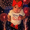 baby, blue_skirt, celebration, child, clothing, colorful, cute, event, festive, fireworks, headwear, holiday, night, outdoor, patriotic, person, portrait, red_bow, sparkler, stars