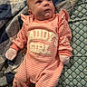 baby, blanket, child, cozy, cute, daddys_girl, indoors, infant, looking_up, lying_down, mittens, newborn, pattern, person, pink_clothing, portrait, quilt, sleepwear, soft_lighting, striped_outfit