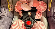 Saige joined the competition — help win amazing prizes! baby, car_seat, pacifier, pink_clothing, striped_outfit, infant, child, seatbelt, safety, cute, wide_eyes, indoor, person, newborn, clothing, baby_gloves, baby_mittens, face, head, portrait