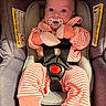 baby, baby_gloves, baby_mittens, car_seat, child, clothing, cute, face, head, indoor, infant, newborn, pacifier, person, pink_clothing, portrait, safety, seatbelt, striped_outfit, wide_eyes