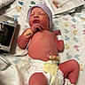 newborn, baby, infant, hospital, blanket, diaper, hat, medical_band, monitor, umbilical_clamp, lying_down, cute, sleeping, healthcare, child, person, skin, bed, pattern, pink