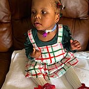 Elyse is registered to the contest to win money with this photo: blanket, brown_couch, child, colorful_clothing, cute, expression, hair_ties, home, indoor, medical_device, person, plaid_dress, portrait, red_shoes, sitting, soft_focus, toddler, tracheostomy, white_tights, young_child