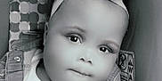 Elyse joined the competition — help win amazing prizes! baby, child, headband, car_seat, warning_label, face, portrait, infant, monochrome, cute, clothing, seatbelt, closeup, expression, indoors, soft_light, young_child, person, baby_girl, headwear