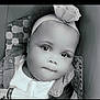 baby, child, headband, car_seat, warning_label, face, portrait, infant, monochrome, cute, clothing, seatbelt, closeup, expression, indoors, soft_light, young_child, person, baby_girl, headwear