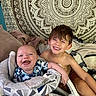 baby, child, smiling, happy, infant, brother, sitting, indoors, blanket, tapestry, pattern, cushion, seat, portrait, cute, fun, family, young, playful, joy