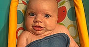 Ryder joined the competition — help win amazing prizes! baby, infant, child, bath, blue_cloth, colorful, bath_seat, face, expression, skin, hand, finger, water_drops, cute, playful, indoors, portrait, young, smile, chubby