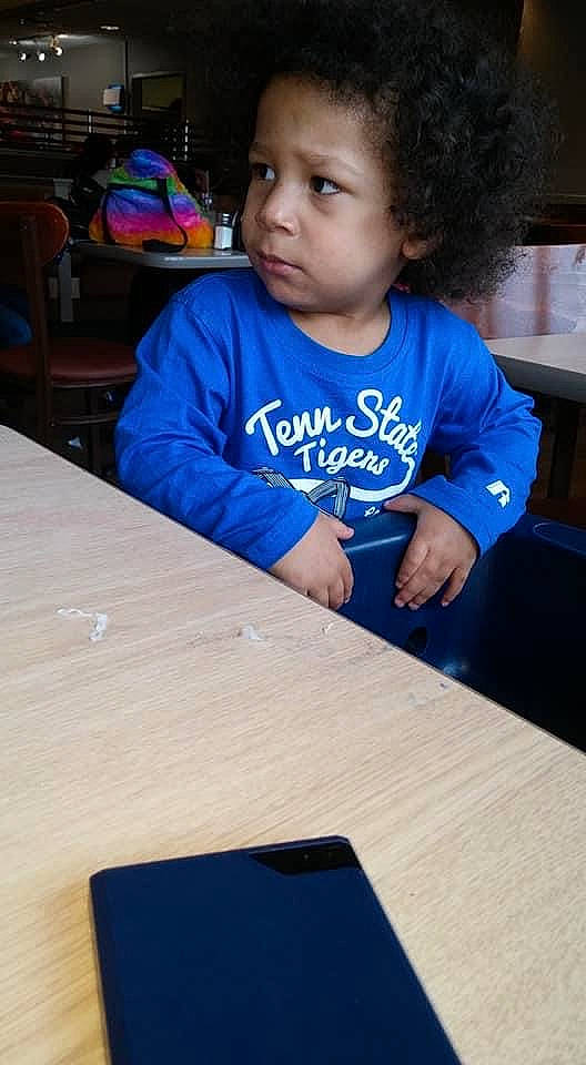 Lamar is registered to the contest to win money with this photo: blue, chair, child, desk, electric_blue, event, fun, furniture, gadget, games, happy, indoor_games_and_sports, leisure, person, recreation, room, sitting, t_shirt, table, toddler