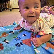 Allison is registered to the contest to win money with this photo: baby, blanket, carpet, child, clothing, colorful, cute, earrings, floor, floral_pattern, furniture, hand, happy, head, indoor, person, portrait, skin, smiling, toddler