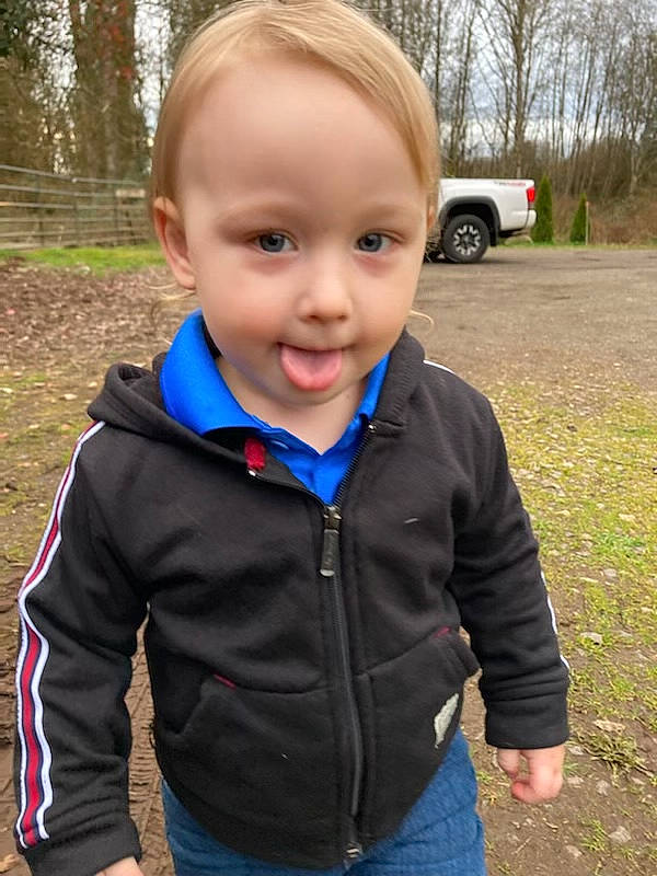 Jackson is registered to the contest to win money with this photo: car, child, denim, electric_blue, eye, face, grass, happy, jacket, jeans, neck, person, plant, recreation, sleeve, smile, t_shirt, tire, toddler, tree