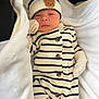 newborn, baby, infant, blanket, striped_clothing, hat, bear_patch, mittens, cozy, sleepy, cute, portrait, soft, warm, lying_down, small, child, knitwear, white, black_stripes