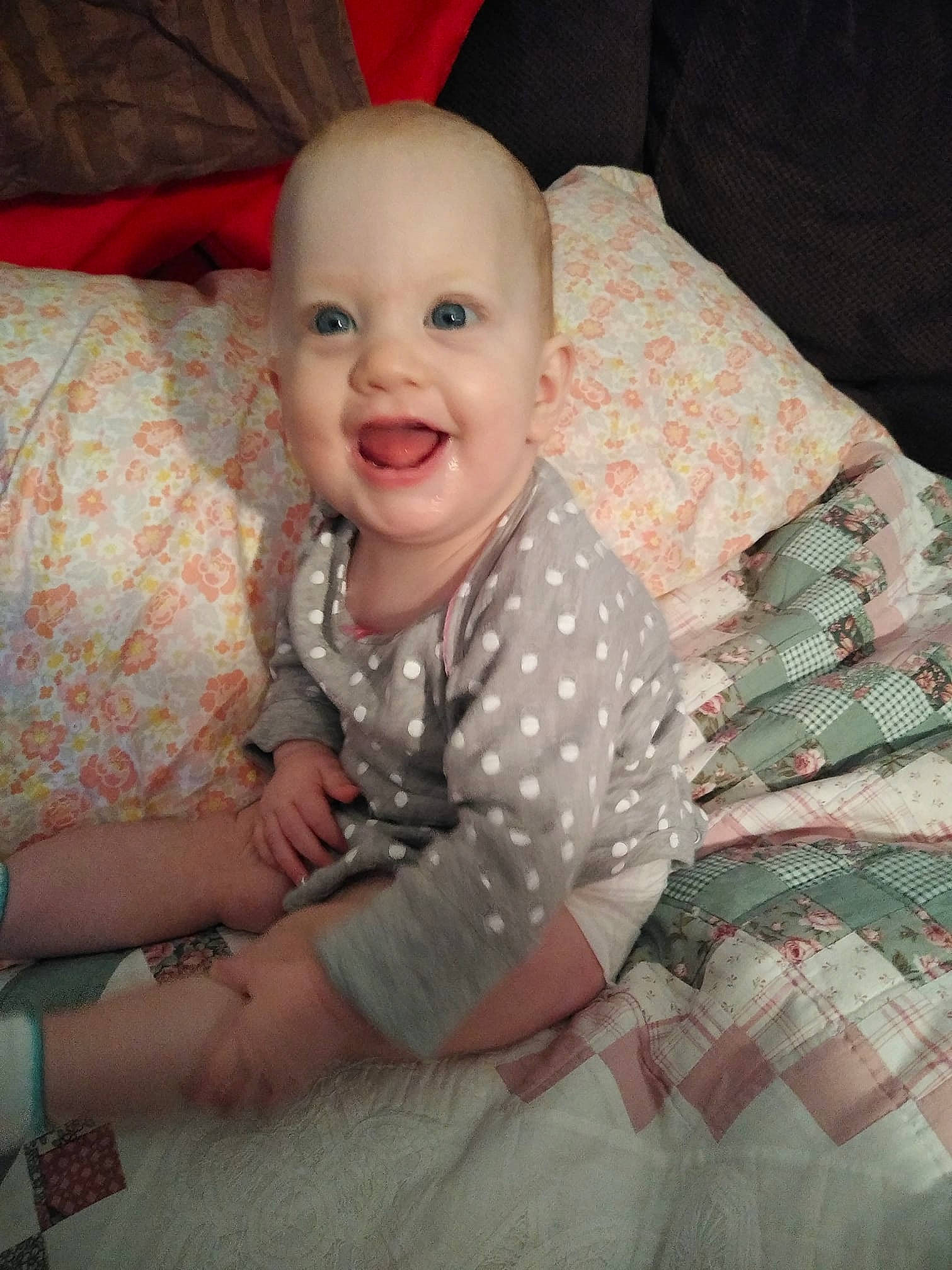 Rosie is registered to the contest to win money with this photo: cheek, child, day, eye, face, girl, hair, head, human_hair_color, infant, iris, mouth, nose, person, pink, product, sitting, skin, smile, textile