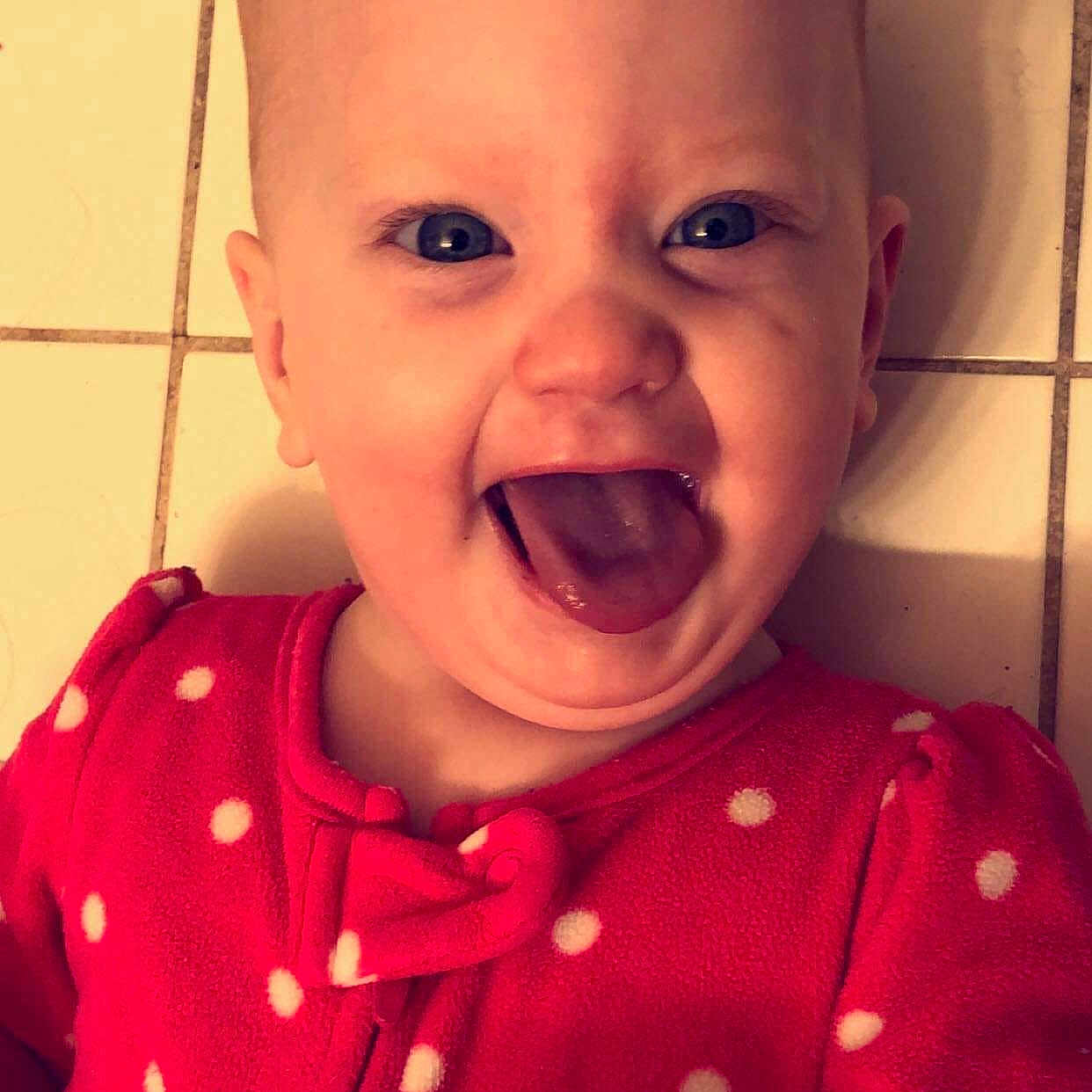 Rosie is registered to the contest to win money with this photo: cheek, child, chin, day, emotion, eye, eyebrow, face, facial_expression, forehead, head, infant, lip, nose, person, pink, skin, smile, toddler, tooth