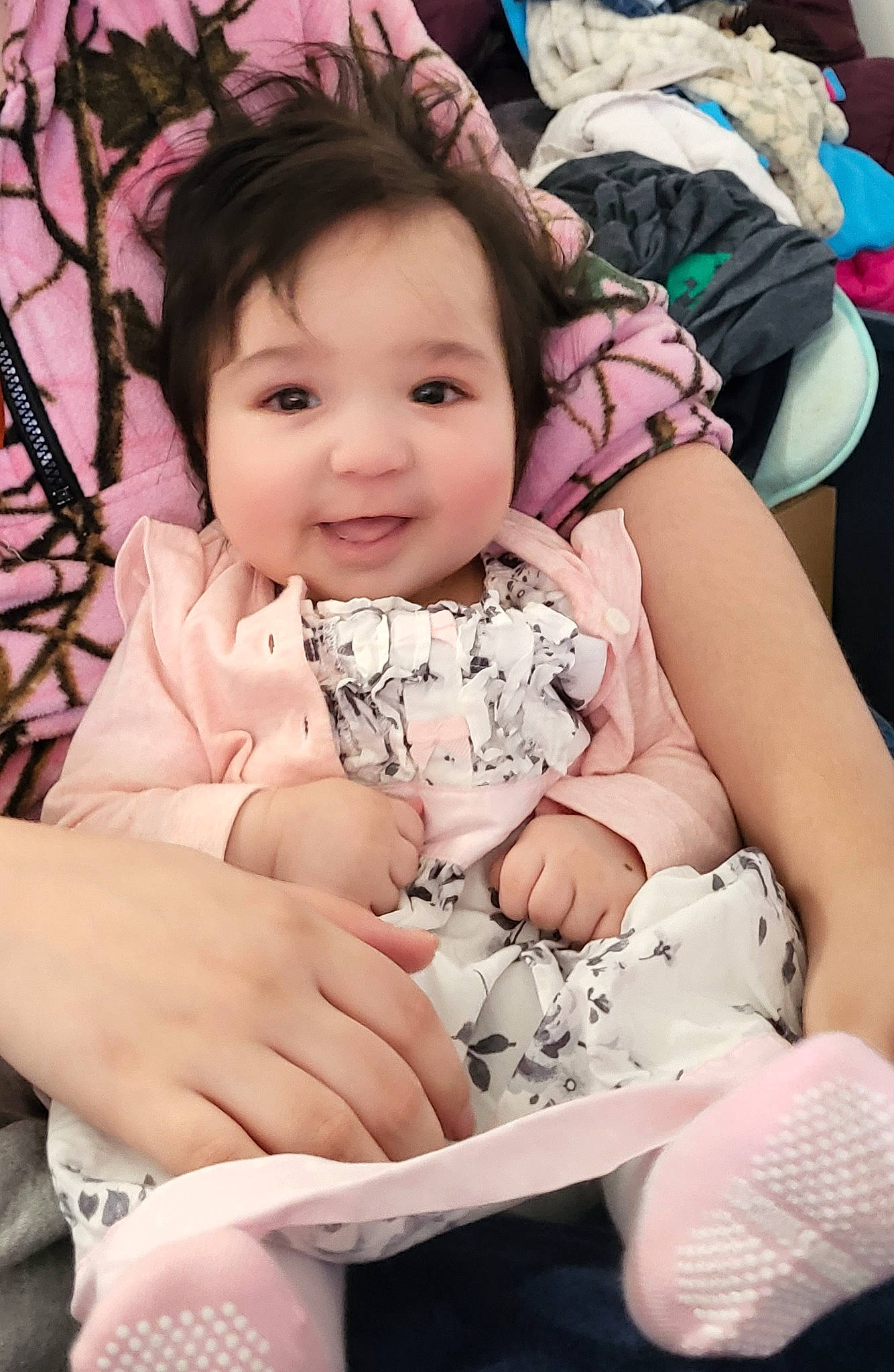 Carrie joined the competition — help win amazing prizes! arm, baby, baby_toddler_clothing, black_hair, cheek, child, comfort, finger, fun, gesture, hand, happy, joy, pattern, person, pink, playing_with_kids, sitting, skin, sleeve