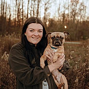 Moose joined the competition — help win amazing prizes! woman, dog, pug, outdoor, smiling, portrait, nature, trees, field, autumn, person, pet, animal, holding, casual_clothing, happy, brown, grass, sunlight, seasonal