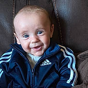 Ryan joined the competition — help win amazing prizes! baby, child, smiling, blue_eyes, adidas_jacket, sportswear, leather_chair, cozy, portrait, happy, cute, indoor, seated, clothing, young_child, person, face, jacket, zipper, casual