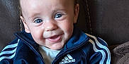Ryan joined the competition — help win amazing prizes! baby, child, smiling, blue_eyes, adidas_jacket, sportswear, leather_chair, cozy, portrait, happy, cute, indoor, seated, clothing, young_child, person, face, jacket, zipper, casual