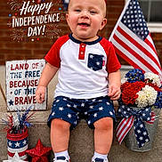 Weston Lee Bowles joined the competition — help win amazing prizes! baby, child, infant, smiling, portrait, independence_day, american_flag, patriotic, red_white_blue, fireworks, stars, flowers, outdoor, brick_wall, steps, sitting, clothing, sneakers, holiday_decoration, text_overlay