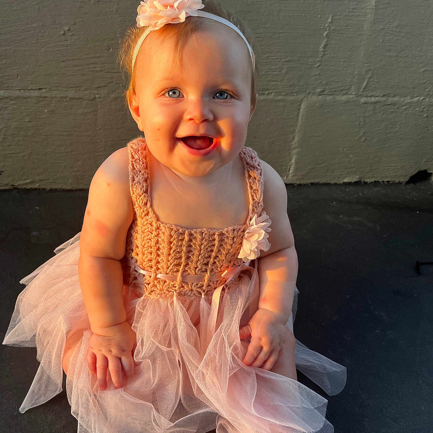 Mylee joined the competition — help win amazing prizes! baby, barefoot, blue_eyes, child, cute, dress, flower, happy, headband, infant, outdoor, person, pink, portrait, shadow, sitting, skin, smiling, sunlight, tutu_dress