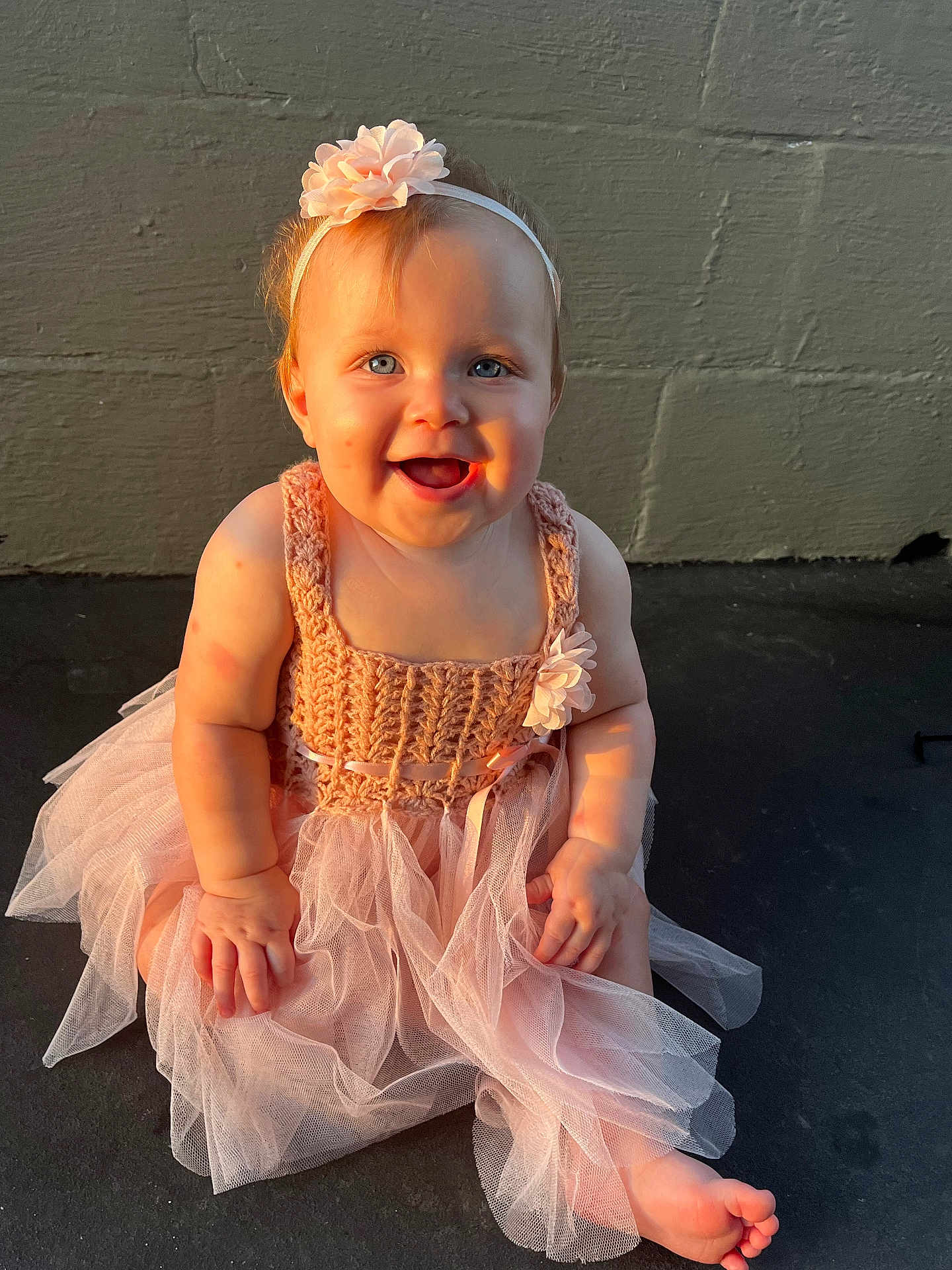 Mylee joined the competition — help win amazing prizes! baby, child, tutu_dress, pink, headband, flower, smiling, blue_eyes, barefoot, sitting, sunlight, shadow, outdoor, cute, portrait, happy, infant, dress, person, skin