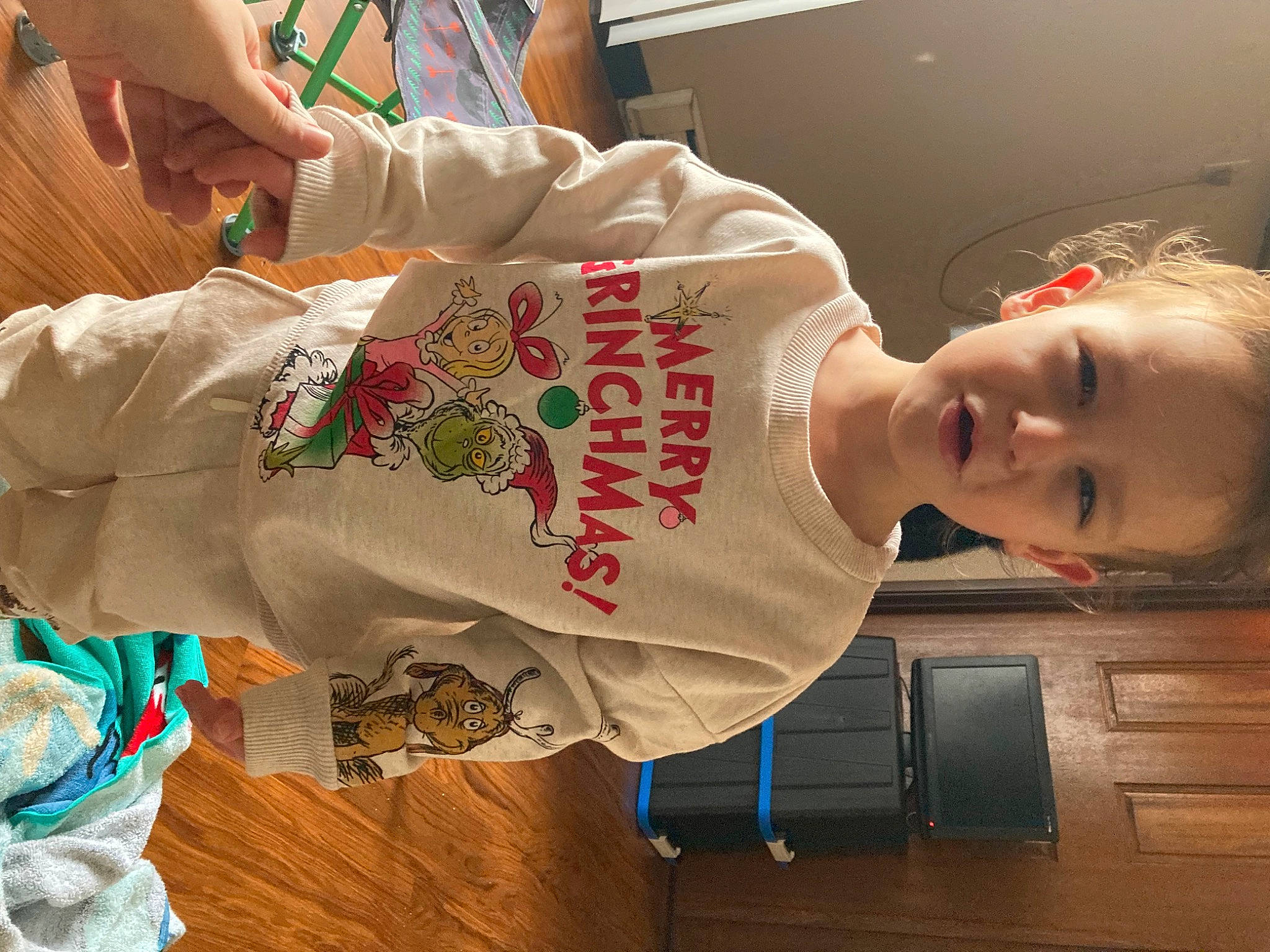 Emma is registered to the contest to win money with this photo: child, comfort_food, elbow, flooring, happy, person, room, sleeve, smile, toddler, wood, wrist