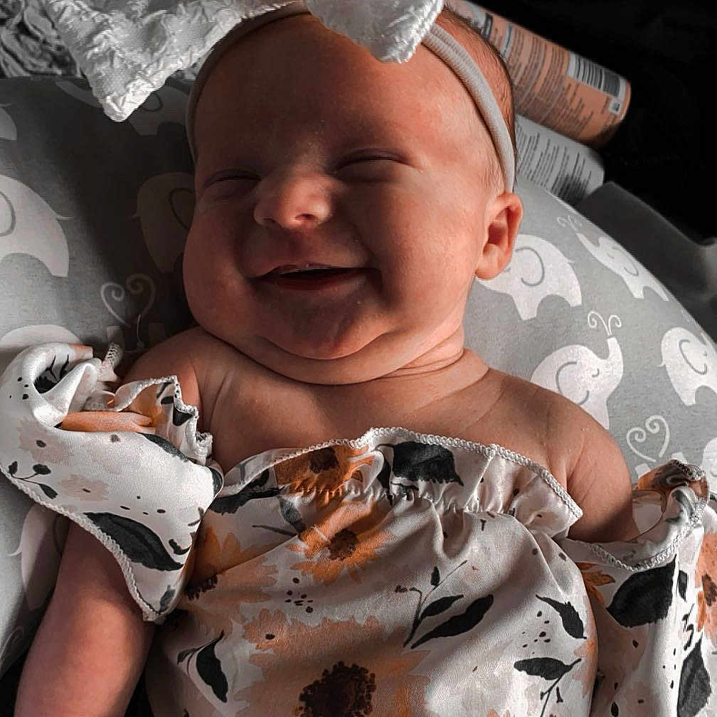 Paisley is registered to the contest to win money with this photo: accessories, baby, beverage, clothing, dress, face, furniture, glove, happy, hat, head, jewelry, necklace, newborn, person, photography, portrait, smile, soda, t_shirt