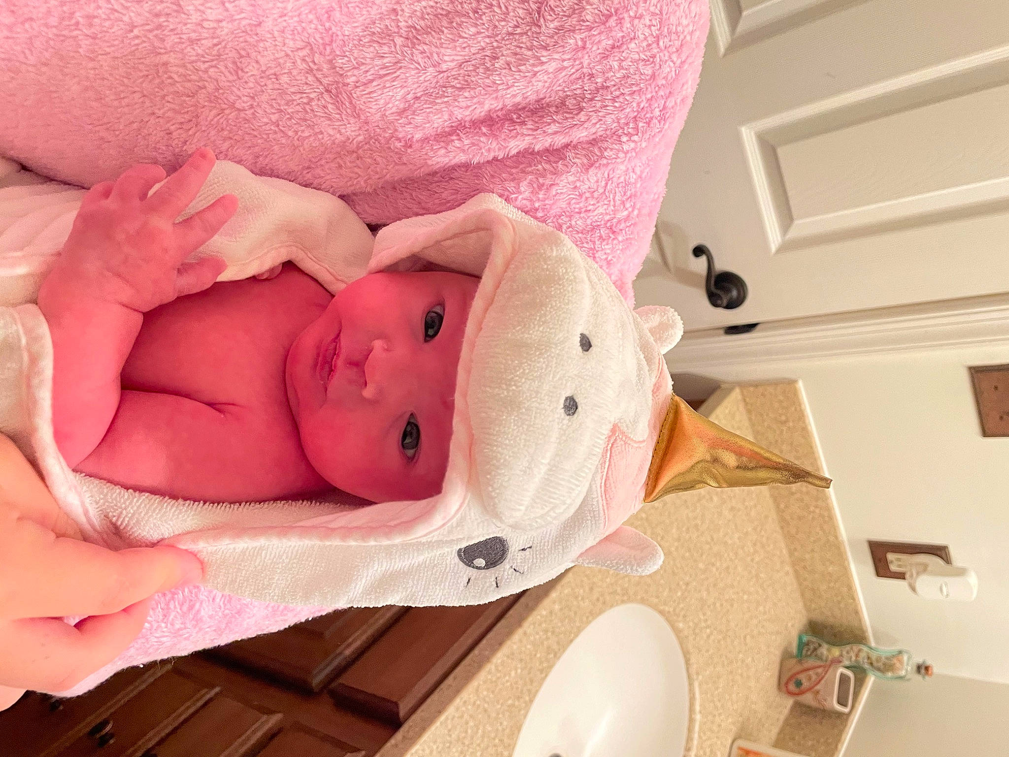 Delanie is registered to the contest to win money with this photo: arm, baby, baby_products, baby_safety, baby_sleeping, baby_toddler_clothing, bathroom, child, comfort, eyelash, hand, headwear, household_supply, leg, linens, person, pink, plumbing_fixture, textile, toddler