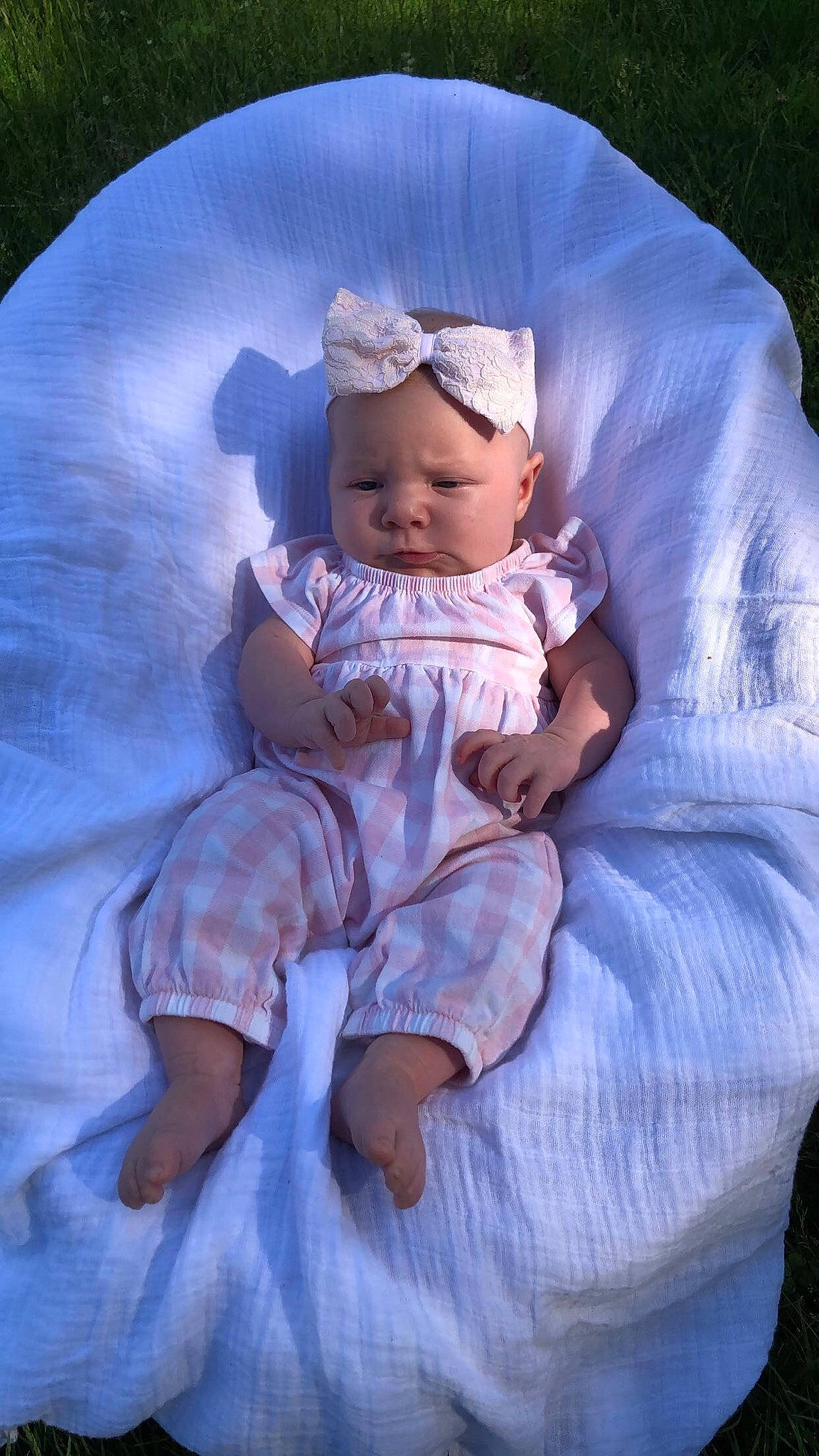 Everleigh joined the competition — help win amazing prizes! azure, baby, baby_toddler_clothing, cheek, comfort, dress, eye, grass, hand, happy, head, headgear, headwear, human_body, iris, person, pink, purple, skin, textile