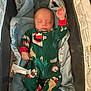 baby, infant, sleeping, pajamas, blanket, crib, child, cozy, soft, bedtime, raised_hand, festive, cute, resting, indoors, comfort, clothing, face, peaceful, newborn