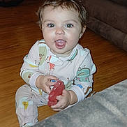 Lunnauh joined the competition — help win amazing prizes! baby, bodypart, chair, clothing, couch, face, finger, furniture, hand, hardwood, head, machine, pajamas, person, photography, plywood, portrait, sitting, wheel, wood