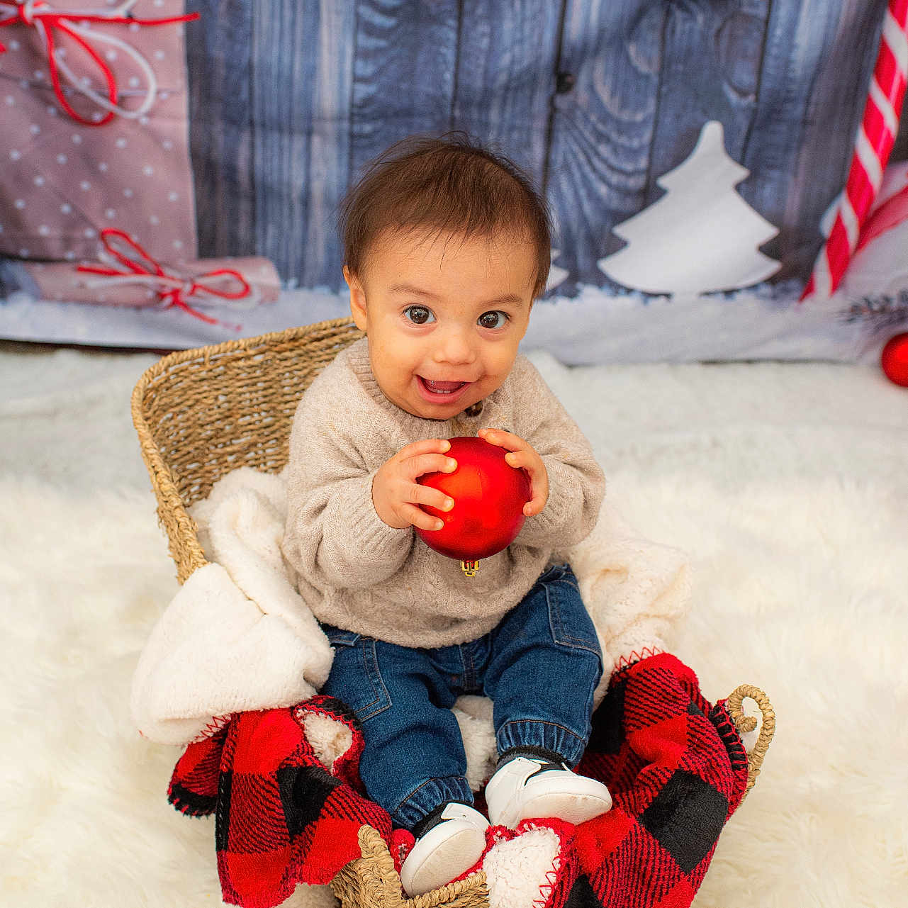 Max joined the competition — help win amazing prizes! baby, basket, blanket, candy_cane, child, christmas_decor, cozy, festive, gift_wrap, happy, holiday, jeans, plaid_blanket, red_ornament, smile, sweater, toddler, white_rug, white_shoes, wooden_background