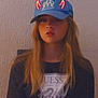black_tshirt, cap, casual, checkered_skirt, devil_horns, fashion, glowing, guess_logo, hat, indoor, lighting, long_hair, moody, person, portrait, red, sitting, texture, wall, young_adult