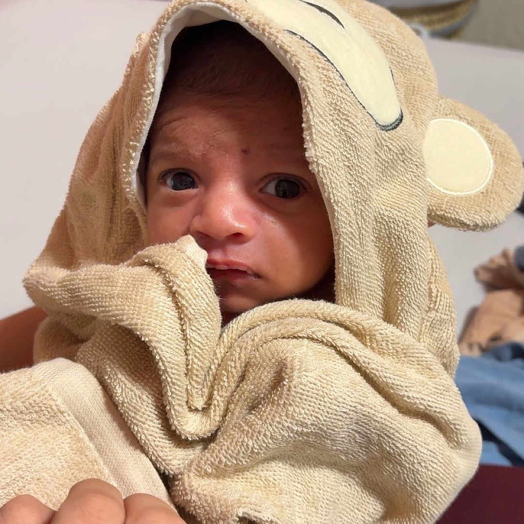 Khizar joined the competition — help win amazing prizes! baby, blanket, bodypart, clothing, face, finger, hand, hat, head, hood, hoodie, knitwear, newborn, person, photography, portrait, quilt, sweater, sweatshirt, towel