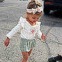 child, toddler, girl, headband, bow, white_shirt, ruffle_shorts, green_shorts, sandals, parking_lot, pavement, car, suv, walking, cute, outdoor, candid, hair, smile, adult_shoe