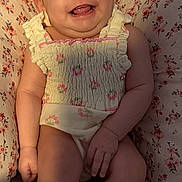 Ariyah Kassing is registered to the contest to win money with this photo: baby, bow, child, closeup, cushion, cute, expression, floral_outfit, happy, headwear, indoor, infant, patterned_cushion, person, pink_bow, portrait, sitting, skin, smiling, young_child