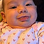 Ariyah Kassing is registered to the contest to win money with this photo: baby, background, child, close_up, clothing, cute, fabric, face, happy, head, heart_pattern, indoors, infant, lying_down, onesie, person, skin, smiling, tongue, young