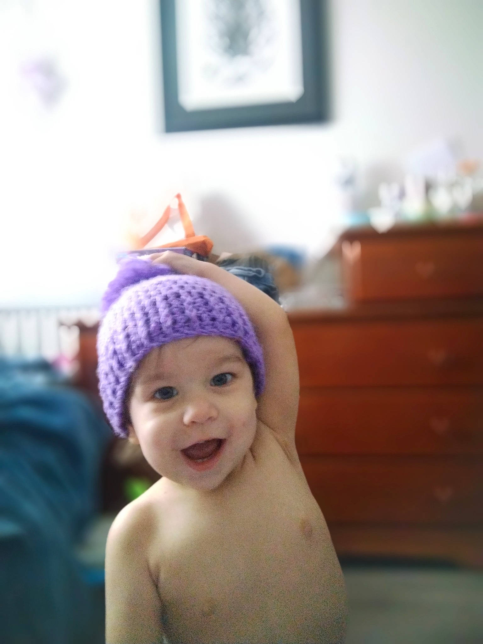 Arilyn is registered to the contest to win money with this photo: beanie, cap, child, electric_blue, fashion_accessory, flooring, fun, happy, hat, headgear, headpiece, headwear, knit_cap, magenta, person, picture_frame, purple, room, smile, toddler