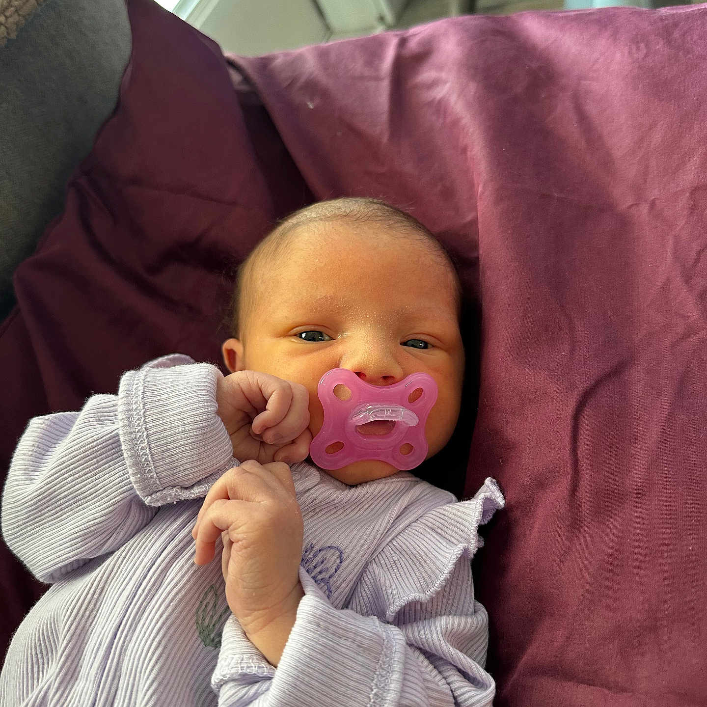 Reeslynn is registered to the contest to win money with this photo: baby, bed, blanket, cozy, cute, eyes, face, indoor, infant, newborn, onesie, pacifier, pillow, pink_pacifier, portrait, purple_blanket, relaxing, sleepy, soft_texture, tiny_hands
