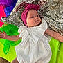 baby, child, colorful_background, cute, expression, fabric, frills, headband, infant, laying_down, neon_green, newborn, one_person, portrait, purple, silver, skin, small_hands, soft_light, white_clothing