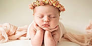 Marla is registered to the contest to win money with this photo: adorable, baby, child, closeup, cute, face, flower_crown, gentle, hands, head, indoors, infant, newborn, pastel_colors, peaceful, portrait, resting, skin, sleeping, soft_fabric