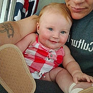 Jax joined the competition — help win amazing prizes! baby, child, smiling, person, tattoo, arm, clothing, red, white, checkered, footwear, shoe, indoor, adult, face, happy, holding, closeup, portrait, blue_eyes