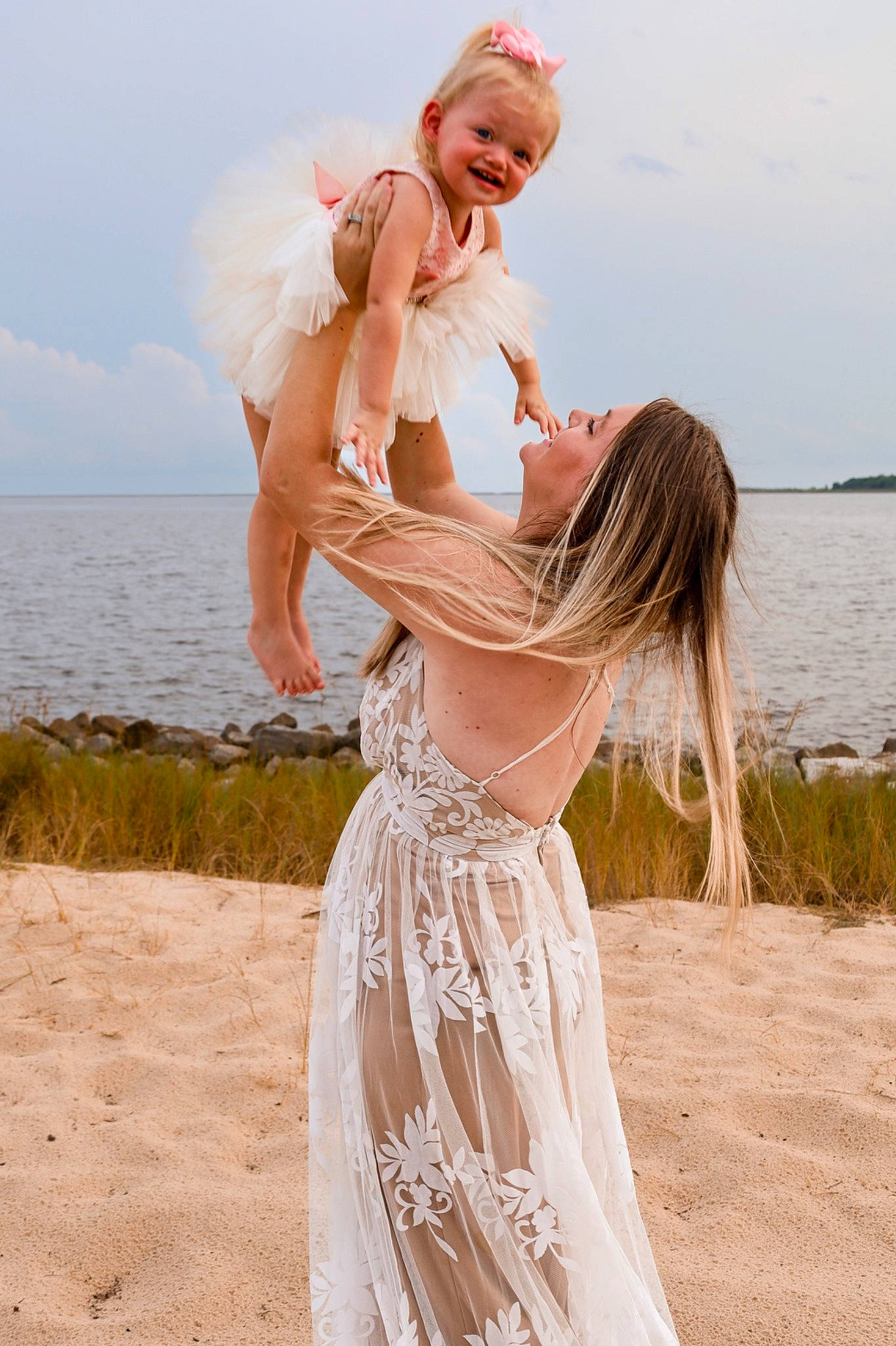 Rylee is registered to the contest to win money with this photo: azure, beach, bridal_clothing, bride, dress, flash_photography, fun, gesture, gown, hairstyle, happy, joy, people_in_nature, people_on_beach, person, sky, standing, summer, sunlight, waist