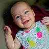 baby, infant, child, smiling, portrait, close_up, blue_eyes, waving, lying_down, colorful_clothing, fruit_pattern, pineapple, strawberry, onesie, happy, face, hands, indoor, candid, cute