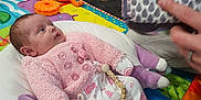 Bonnie-Mae joined the competition — help win amazing prizes! baby, carpet, child, colorful, cozy, curious, cute, floor, hand, indoor, infant, looking, lying_down, pajamas, patterned_clothing, person, pink_clothing, play_mat, soft_toy, toy