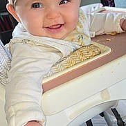 Bonnie-Mae is registered to the contest to win money with this photo: baby, high_chair, messy, food, smiling, child, indoor, face, hand, clothing, mirror, wallpaper, floor, happy, person, seat, cute, infant, home, reaching