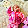 Bonnie-Mae is registered to the contest to win money with this photo: baby, blanket, child, cozy, cute, floor, head, indoor, infant, knitted_sweater, lying_down, milestone, newborn, one_month, pink_clothing, plush_toy, portrait, small, soft_texture, wooden_plaque