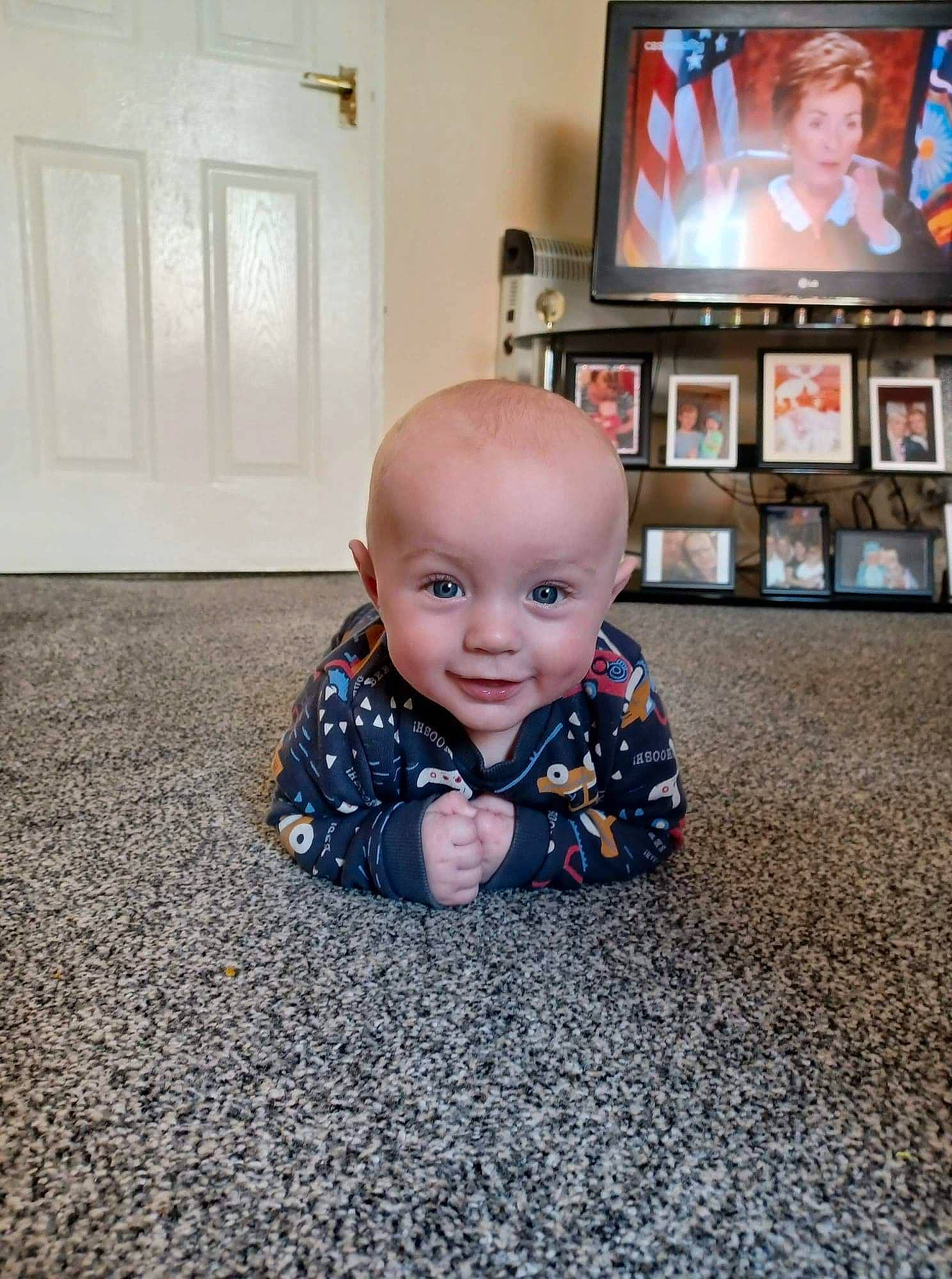 Samuel Scott joined the competition — help win amazing prizes! baby, baby_toddler_clothing, cable_television, carpet, child, crawling, entertainment_center, flat_panel_display, floor, flooring, fun, hardwood, home_appliance, person, picture_frame, sleeve, smile, television, television_set, toddler