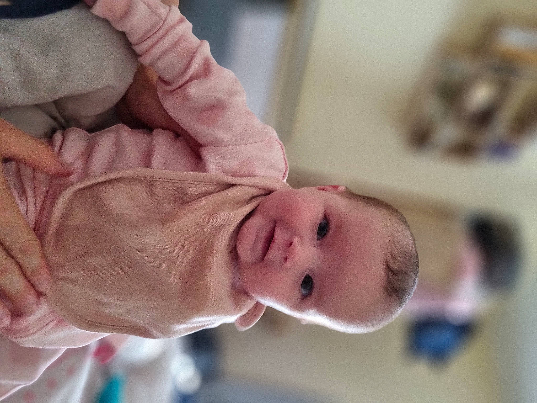 Hallie is registered to the contest to win money with this photo: baby, baby_toddler_clothing, cheek, child, collar, comfort, eyelash, finger, gesture, hair, happy, joy, nail, nose, peach, person, room, skin, sleeve, smile