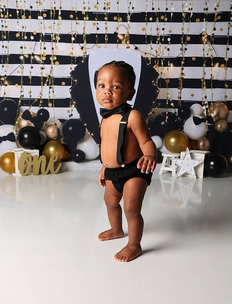 Kaleb is registered to the contest to win money with this photo: arm, baby, barefoot, chest, child, eyewear, fashion_accessory, fashion_design, flooring, foot, fun, happy, human_leg, jewellery, metal, monochrome_photography, person, room, swimwear, thigh